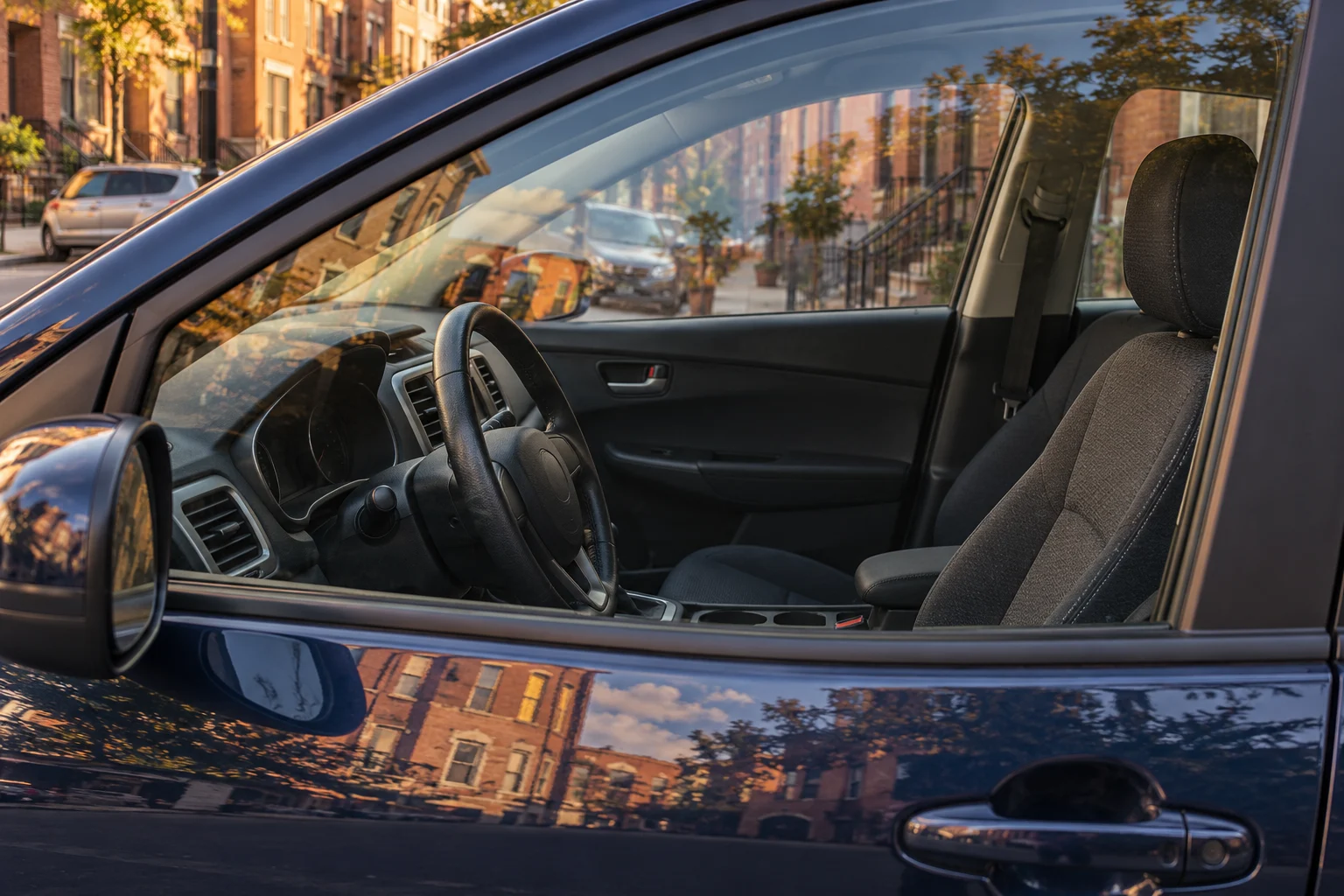 Representative parked car interior seen through a side window.